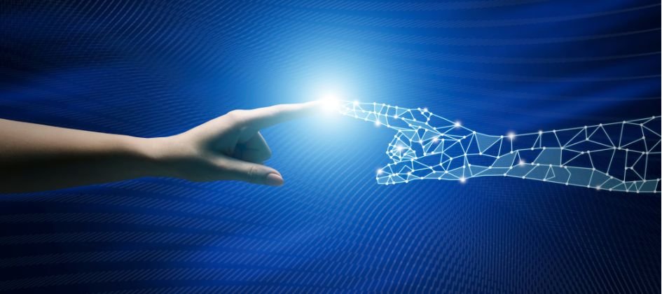 Human hand reaching out to touch a glowing digital wireframe hand